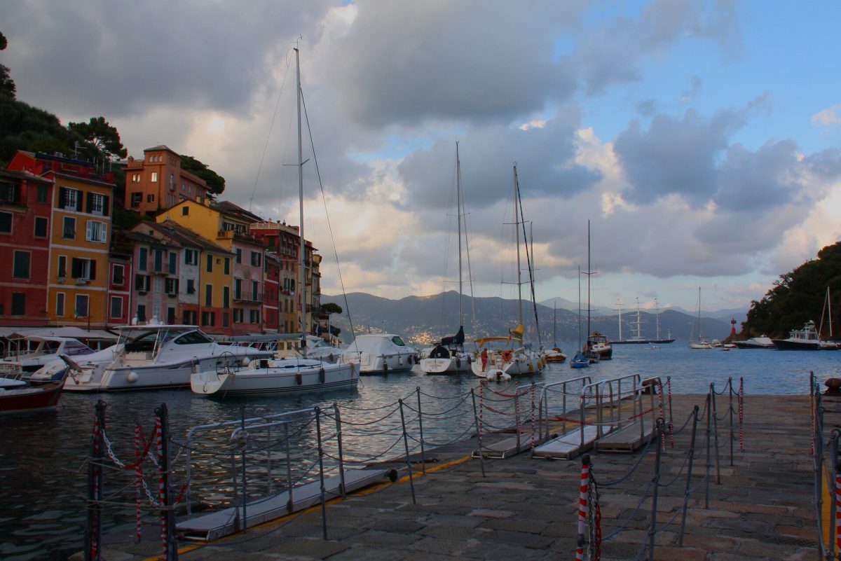 Colourful houses and yachts in the harbour of Portofino at sunset