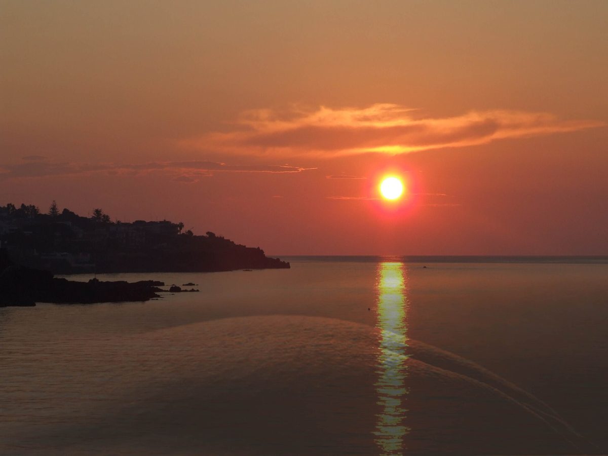Dramatic sunset over the rocky coastline of Sicily in autumn