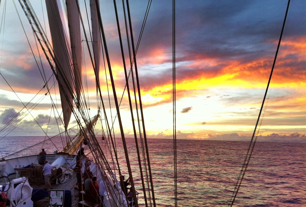 Sunset view from the deck of a sailing ship at sea